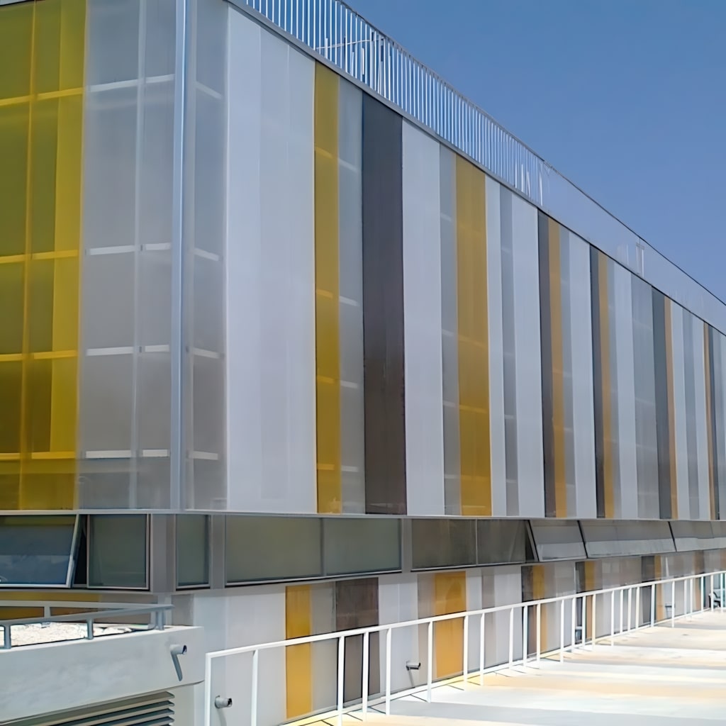 Grey and yellow facade with interlocking polycarbonate panels